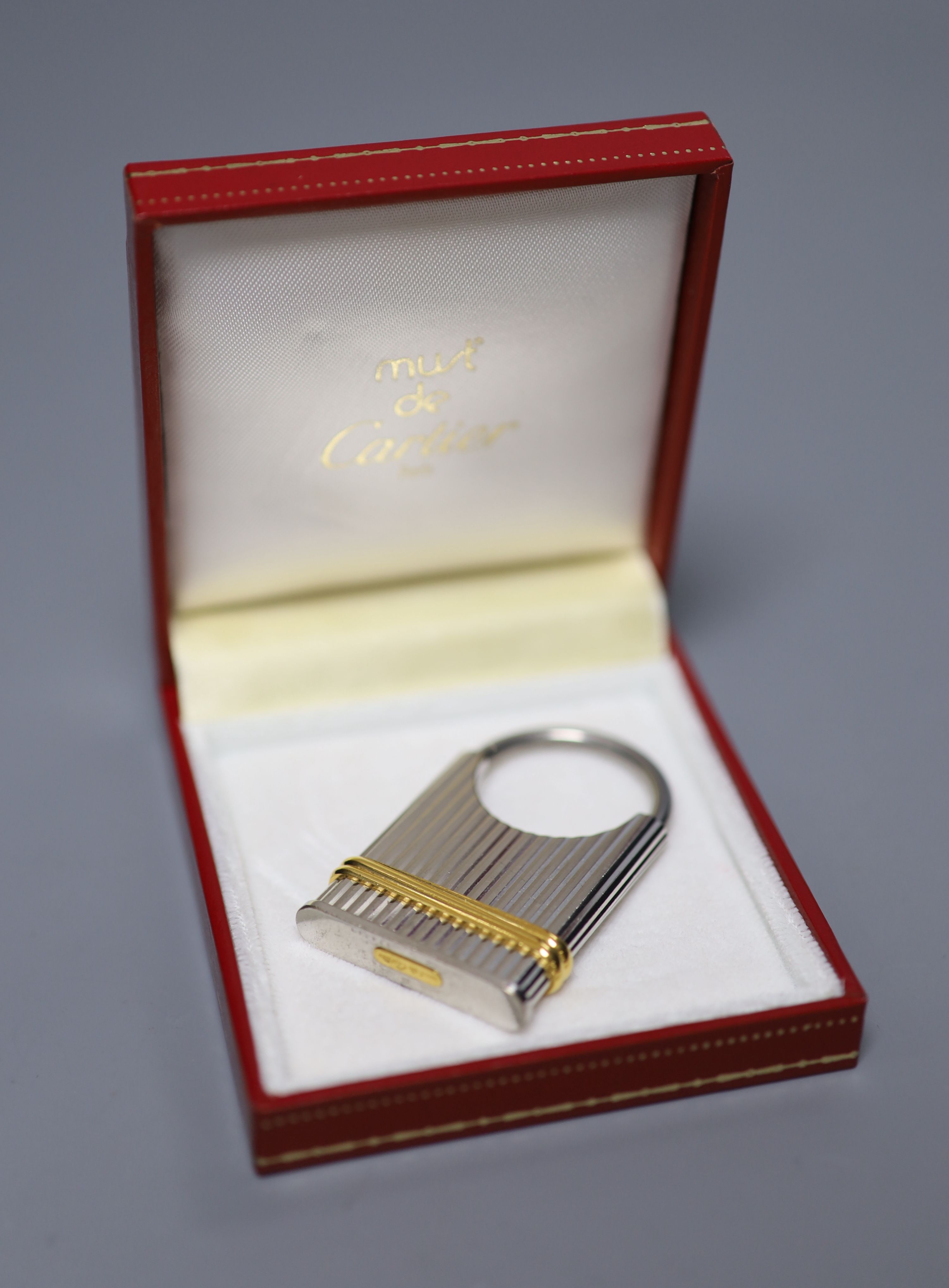 A steel and yellow metal Must de Cartier key fob, 52mm, with Cartier box.